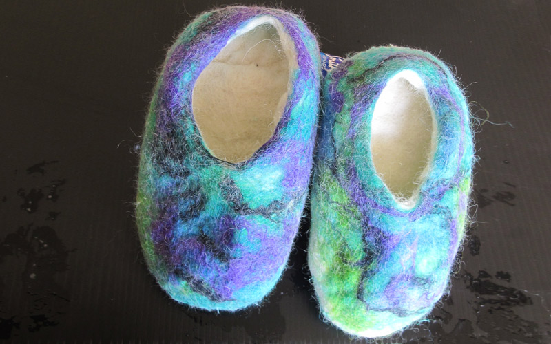 A pair of alpaca fibre slippers in bright colours